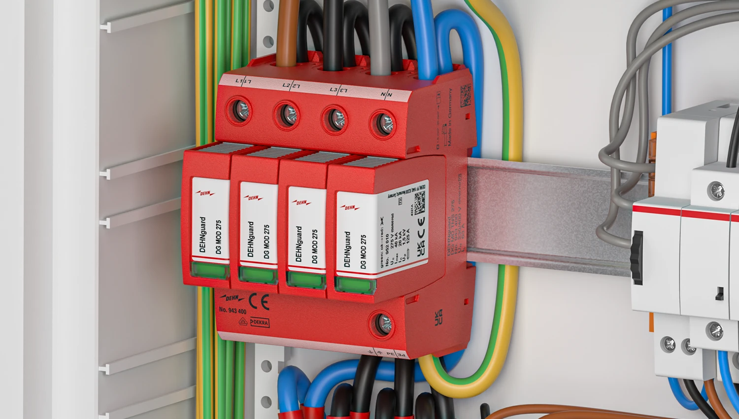 Red surge protection device mounted on a DIN rail inside an electrical cabinet, connected to color-coded cables and adjacent components.