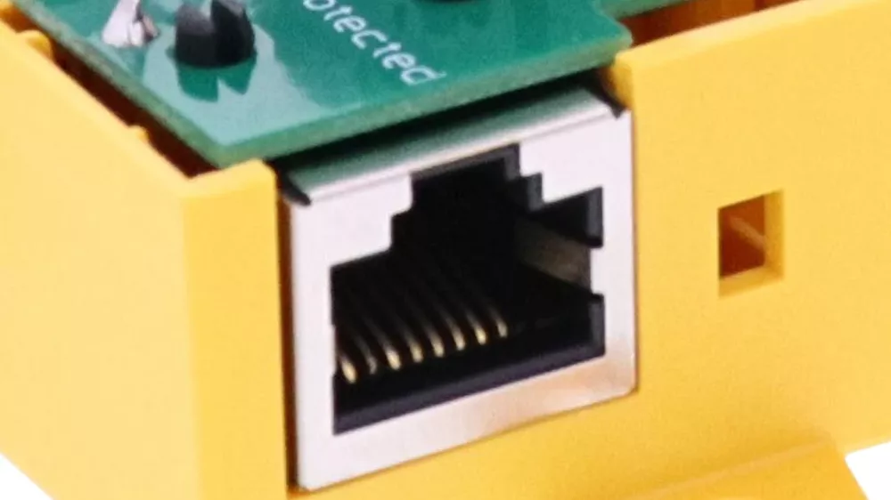 Close-up of an RJ45 Ethernet port on a yellow DEHNbox circuit module.