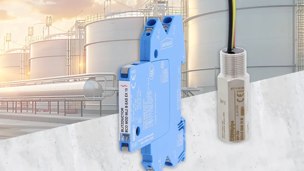 Two electronic components in front of an industrial facility with large storage tanks and a cloudy sky.
