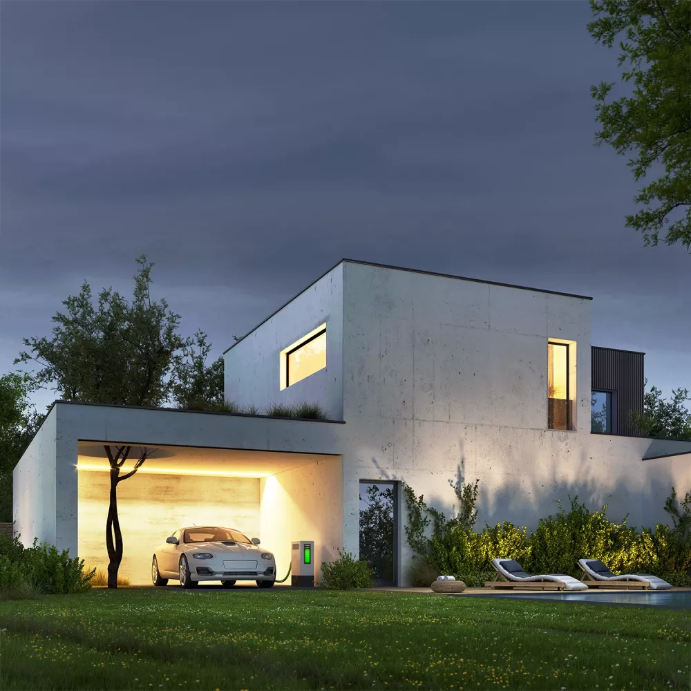 Modern concrete house at dusk with illuminated windows, an electric car charging in the garage, garden lighting, and a pool in the foreground.