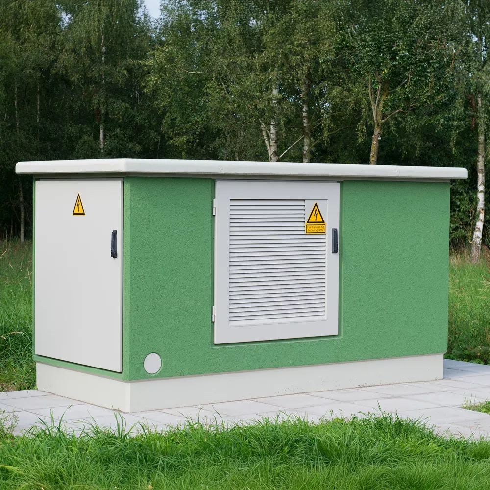 Green transformer station building with ventilation door and high-voltage warning signs, surrounded by grass and trees.